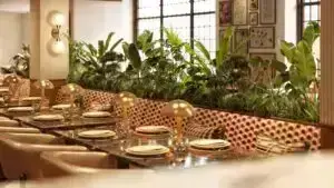 Amelia Mansell Elegant dining area with lush greenery.